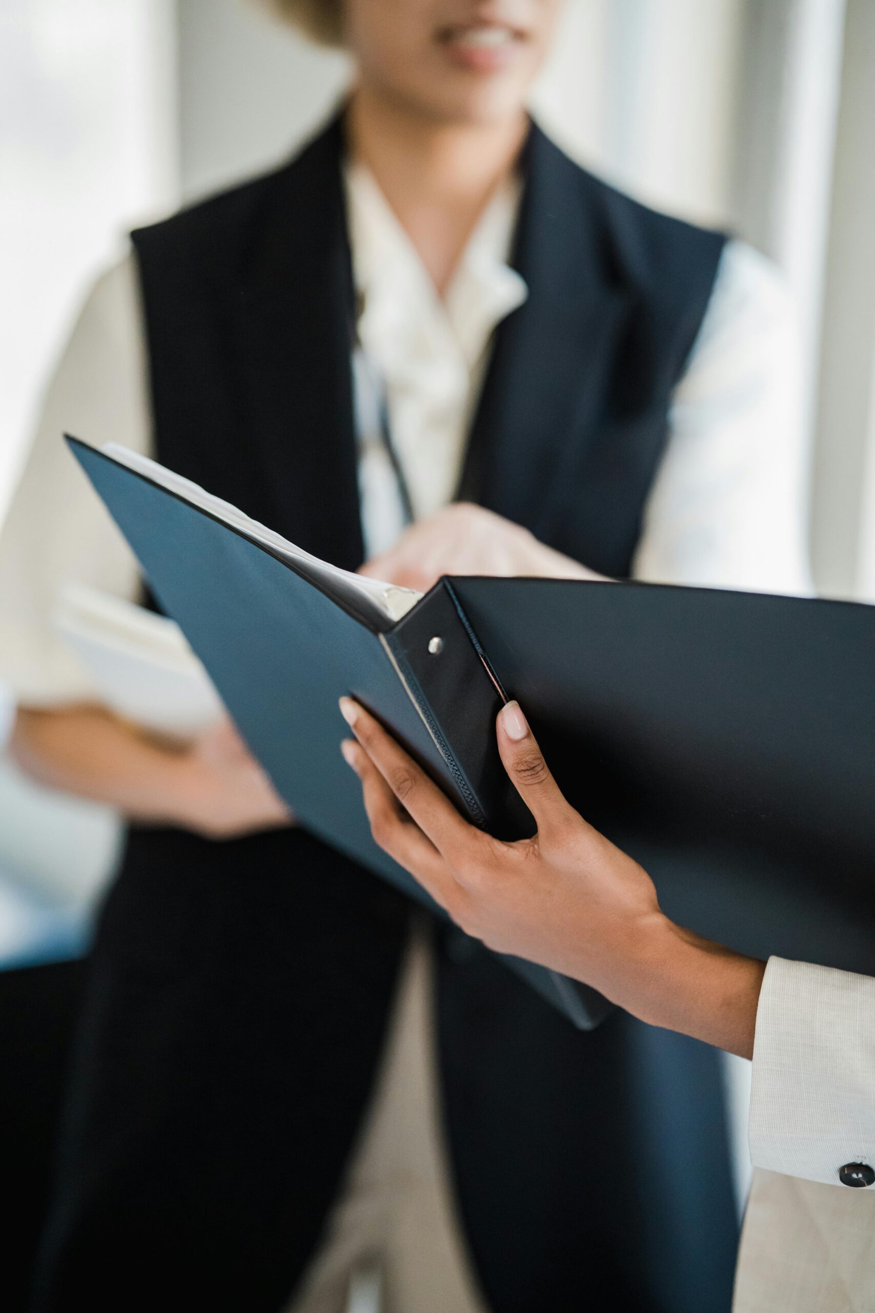 Close-up of professionals discussing documents in an office meeting setting.